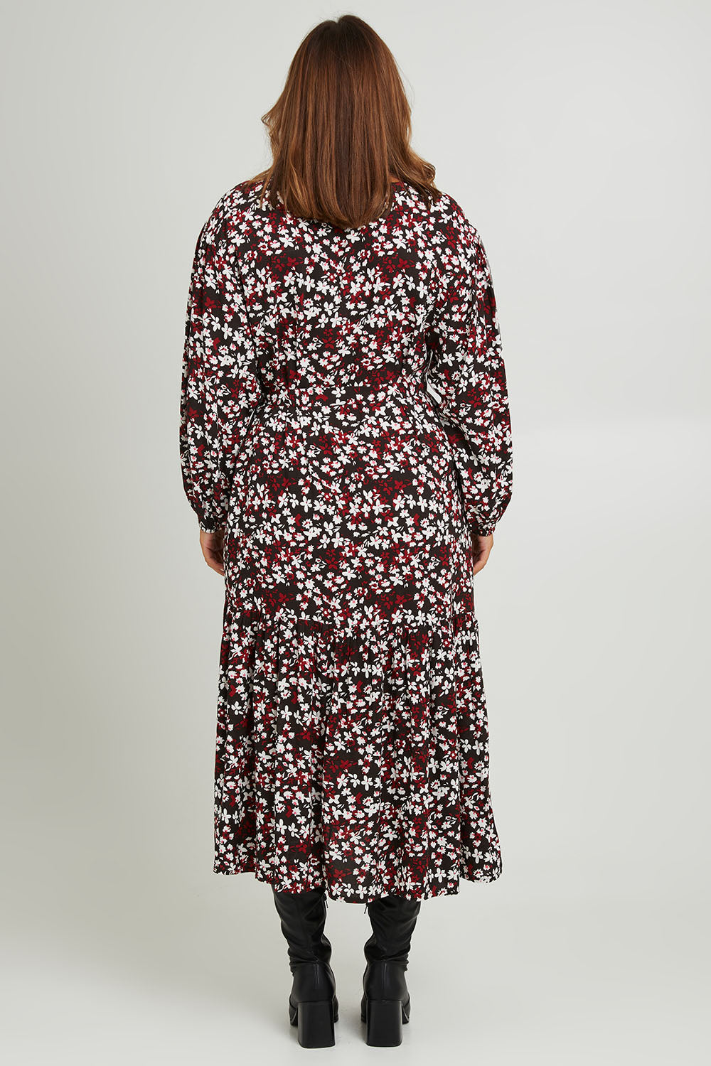 Model Monique wearing size 14 of the Ashley Dress in colour Flutter (Black), from the back