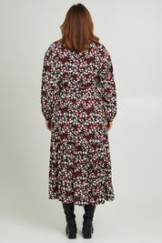 Model Monique wearing size 14 of the Ashley Dress in colour Flutter (Black), from the back