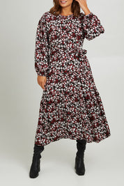 Model Monique wearing size 14 of the Ashley Dress in colour Flutter (Black), from the front, cropped image