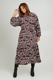 Model Monique wearing size 14 of the Ashley Dress in colour Flutter (Black), from the front, showing the whole outfit