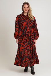 Model Chanel wearing size 16 of the Nikki Cotton Maxi Dress in colour Tigerleaf, from the front, showing the whole outfit