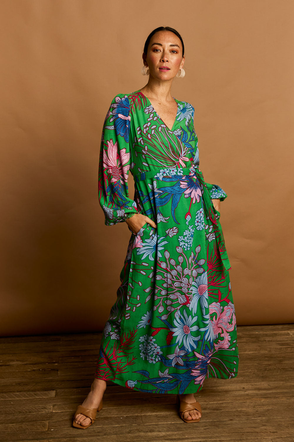Model Katie wearing size 10 of the Daphne Wrap Dress in colour Greengard, from the front, showing the whole outfit