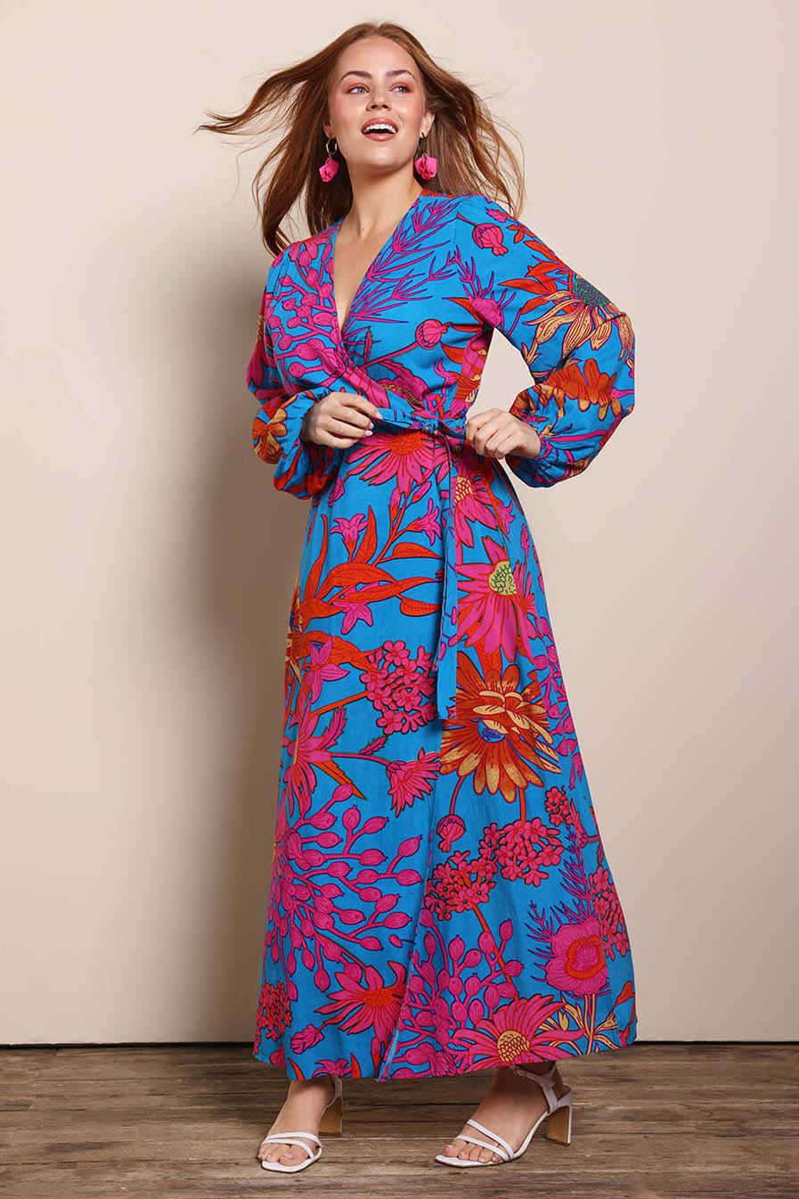 Model Georgiel wearing size 10 of the Daphne Maxi Wrap Dress – Bluegarden in colour Bluegarden, from the front
