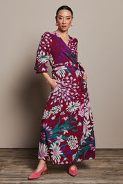 Model Katie wearing size 10 of the Daphne Maxi Wrap Dress in colour Garden, from the front, showing the whole outfit