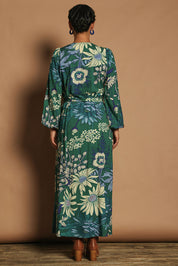 Model Katie wearing size 10 of the Daphne Maxi Wrap Dress in colour Darkgarden (Green), from the back