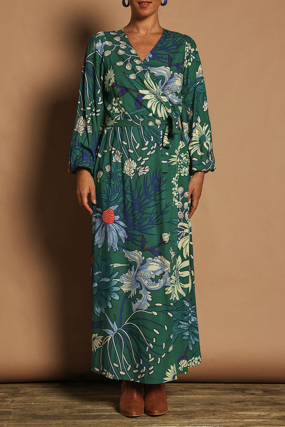 Model Katie wearing size 10 of the Daphne Maxi Wrap Dress in colour Darkgarden (Green), from the front, cropped image