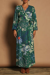 Model Katie wearing size 10 of the Daphne Maxi Wrap Dress in colour Darkgarden (Green), from the front, cropped image