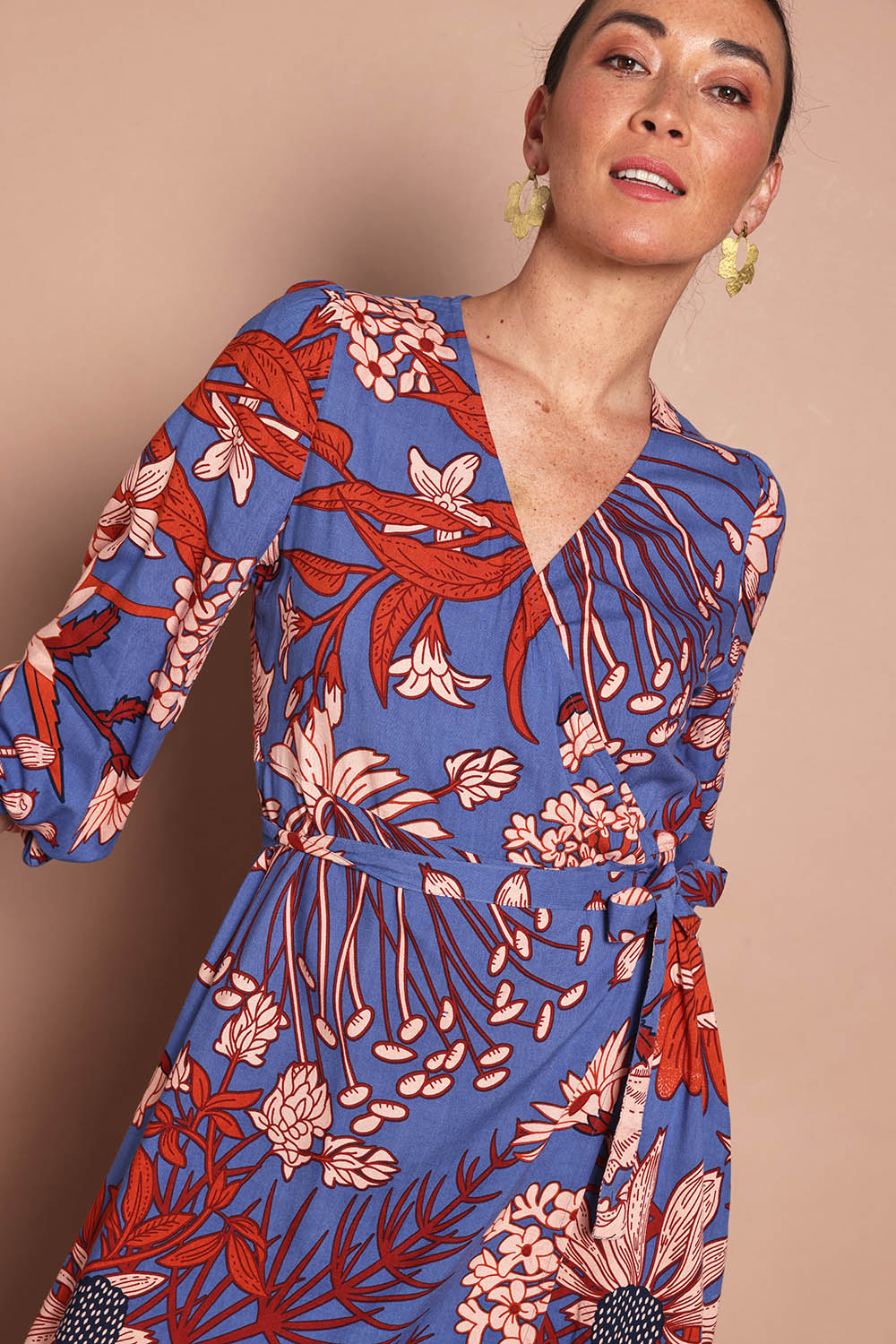 Model Katie wearing size 10 of the Daphne Maxi Wrap Dress in colour Gardenblue (Blue), from the front, cropped image