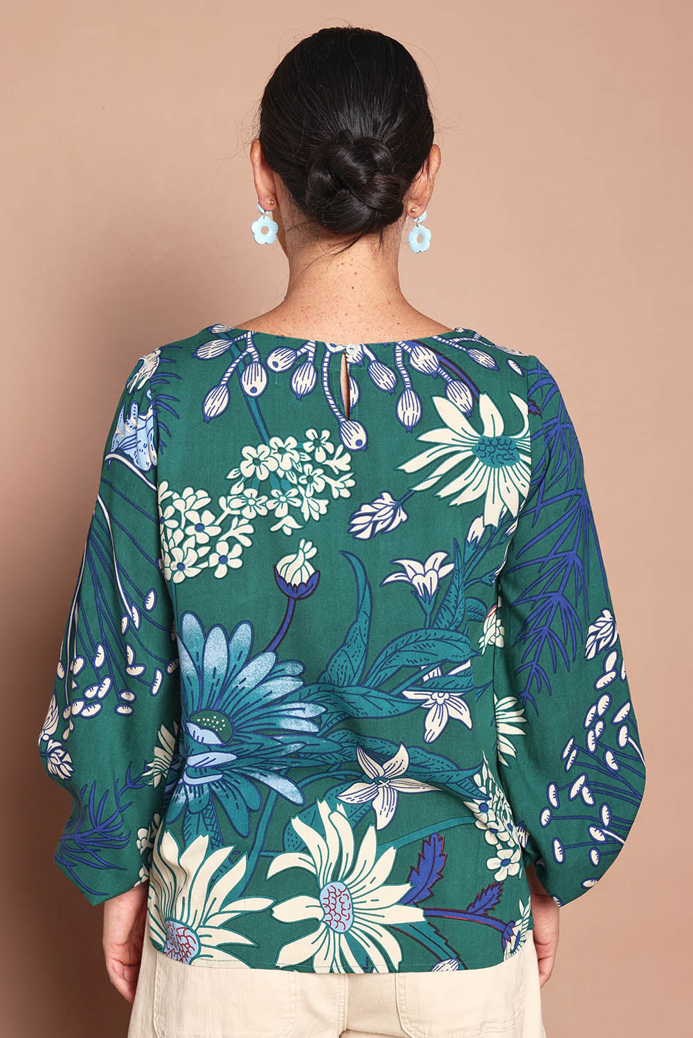 Model Katie wearing size 10 of the Harriet Blouse in colour Deepgreen (Green), from the back