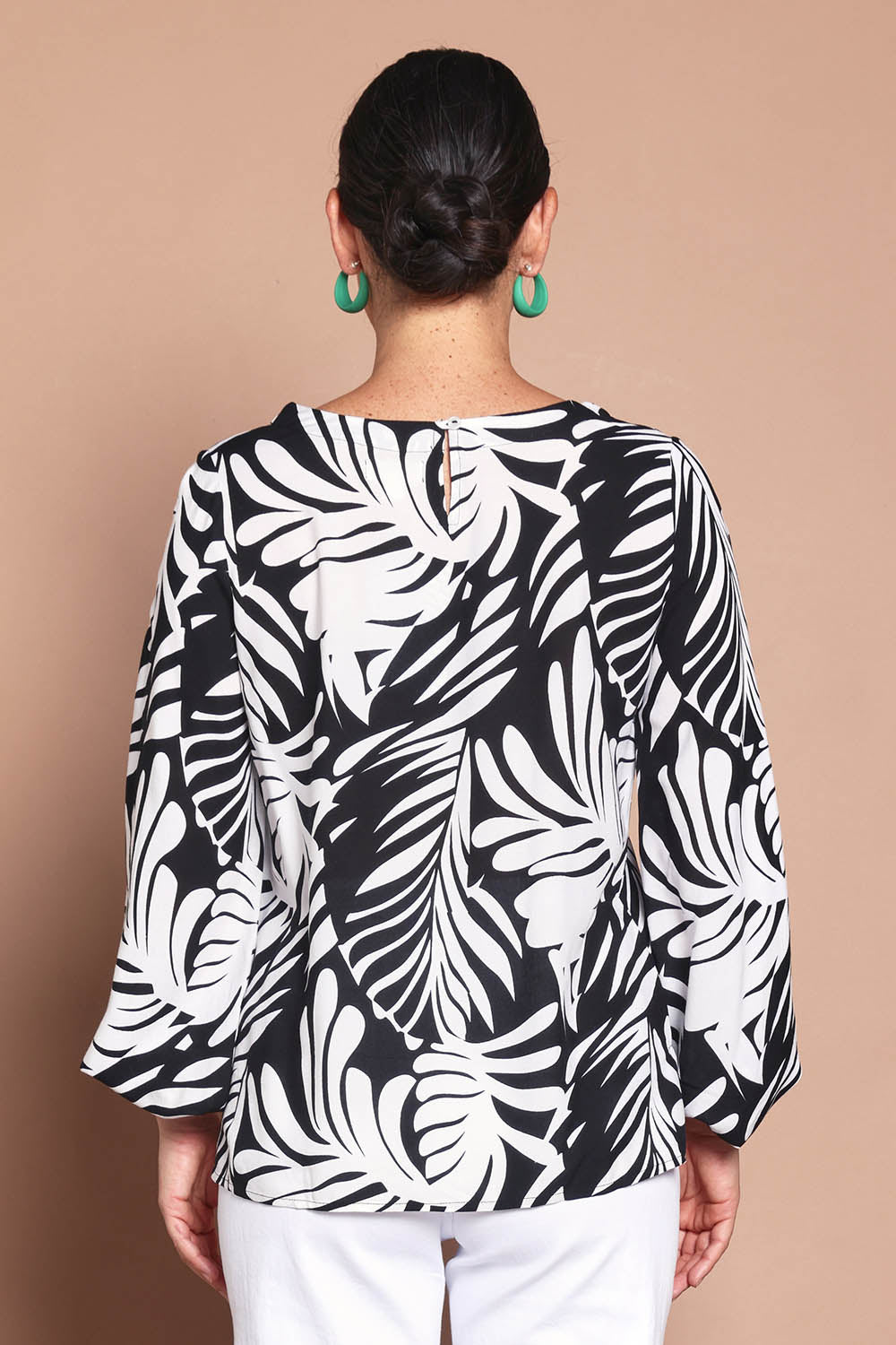 Model Katie wearing size 8 of the Harriet Blouse in colour Fern (Black), from the back