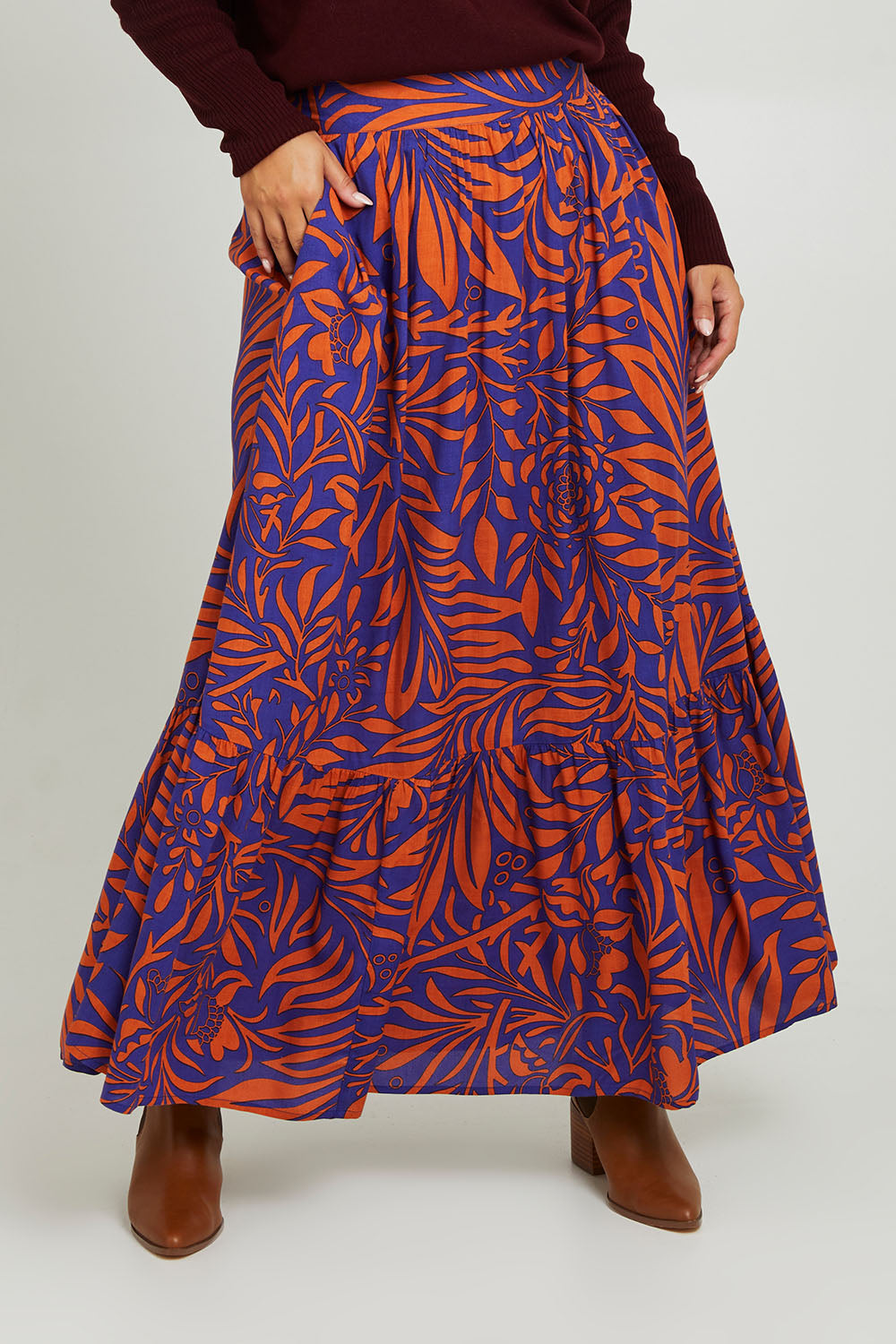 Model Monique wearing size 14 of the Harper Skirt in colour Gardenmaze (Blue), from the front, cropped image