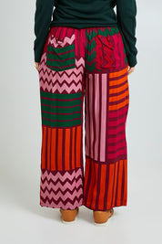 Model Laura wearing size 14 of the Andie Pant in colour Lines (Pink), from the back