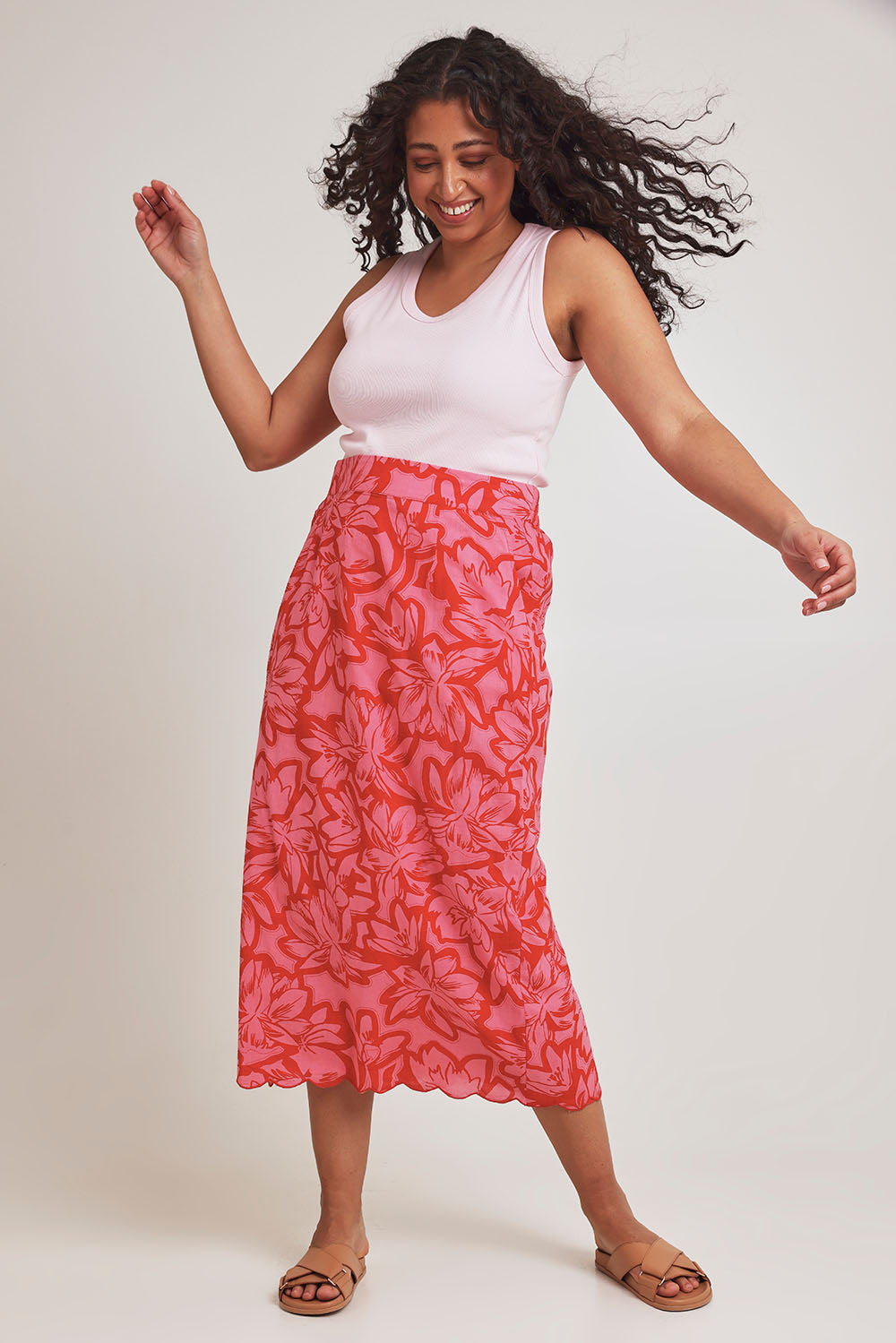 Model Terri-Leigh wearing size 14 of the Camilla Cotton Scalloped Hem Skirt in colour Flowerpop (Red), from the front, showing the whole outfit