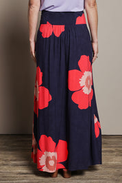 Model Katie wearing size 10 of the Rosie Maxi Skirt in colour Boldflower (Blue), from the back