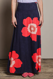 Model Katie wearing size 10 of the Rosie Maxi Skirt in colour Boldflower (Blue), from the front, cropped image