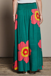 Model Katie wearing size 10 of the Rosie Maxi Skirt in colour Boldgreen (Green), from the back
