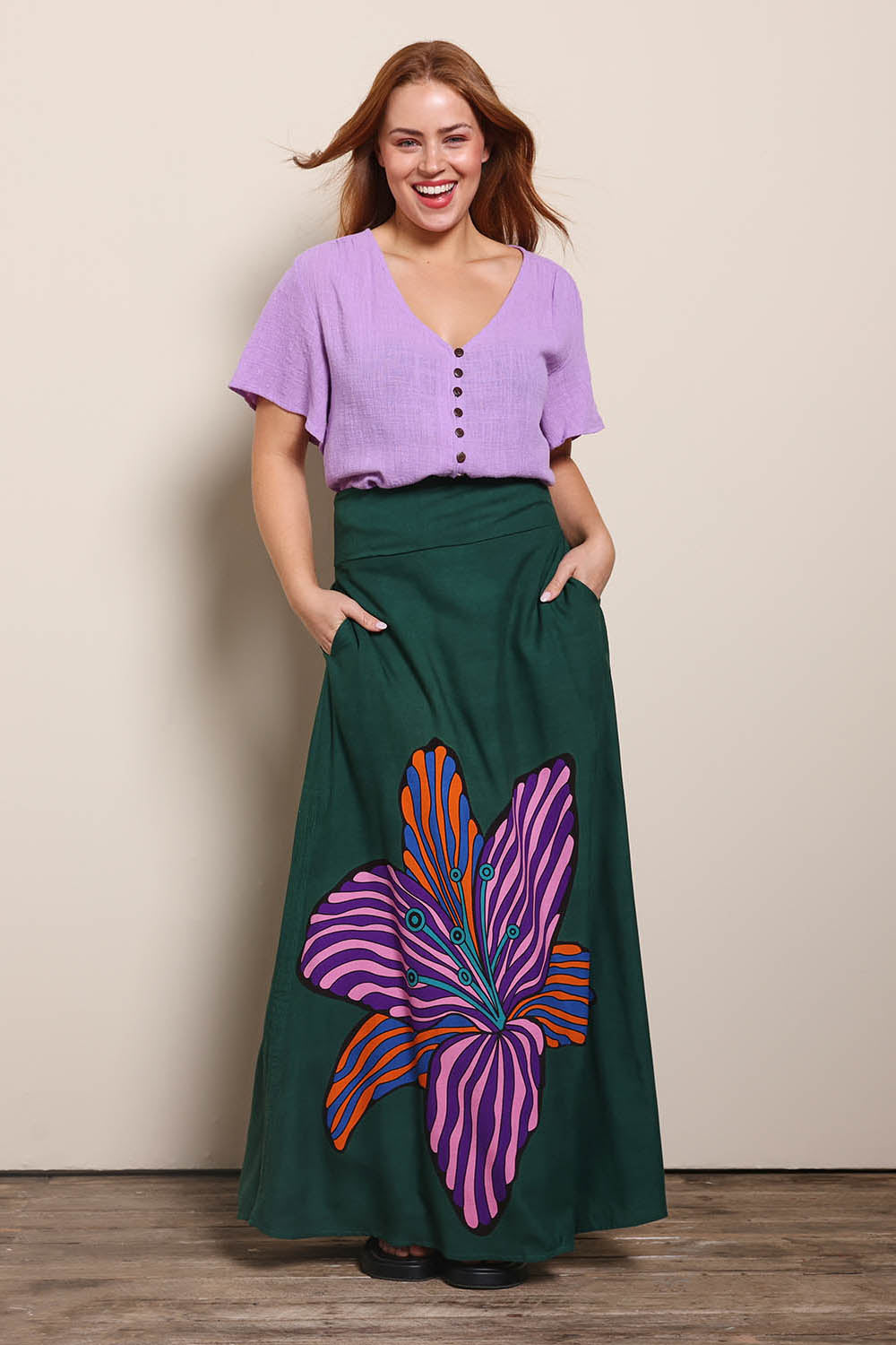 Model Georgiel wearing size 10 of the Rosie Maxi Skirt – Flower in colour Flower, from the front