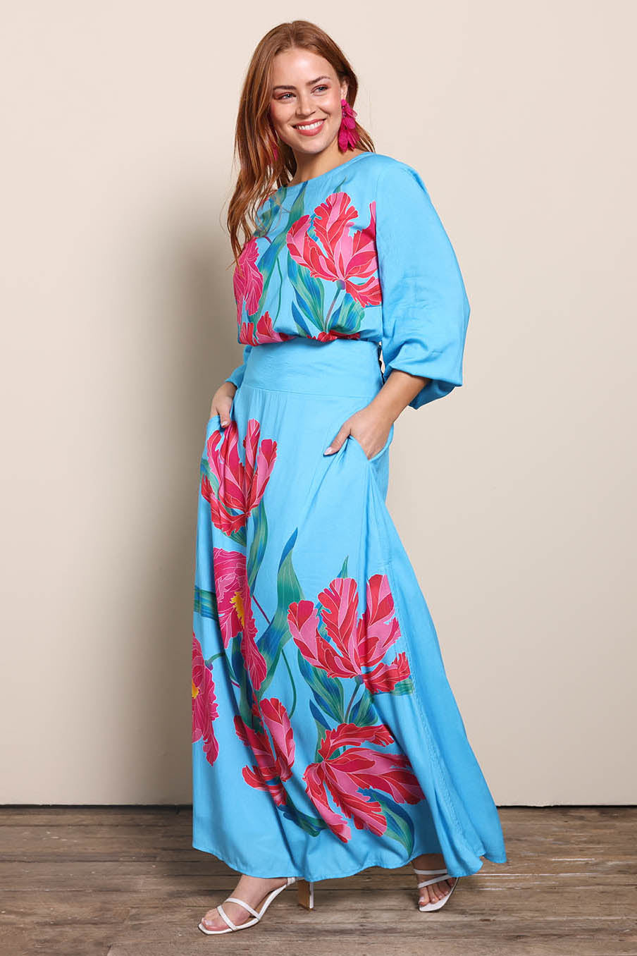 Model Georgiel wearing size 10 of the Rosie Maxi Skirt – Meadow in colour Meadow, from the front