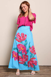 Model Georgiel wearing size 10 of the Rosie Maxi Skirt – Meadow in colour Meadow, from the front