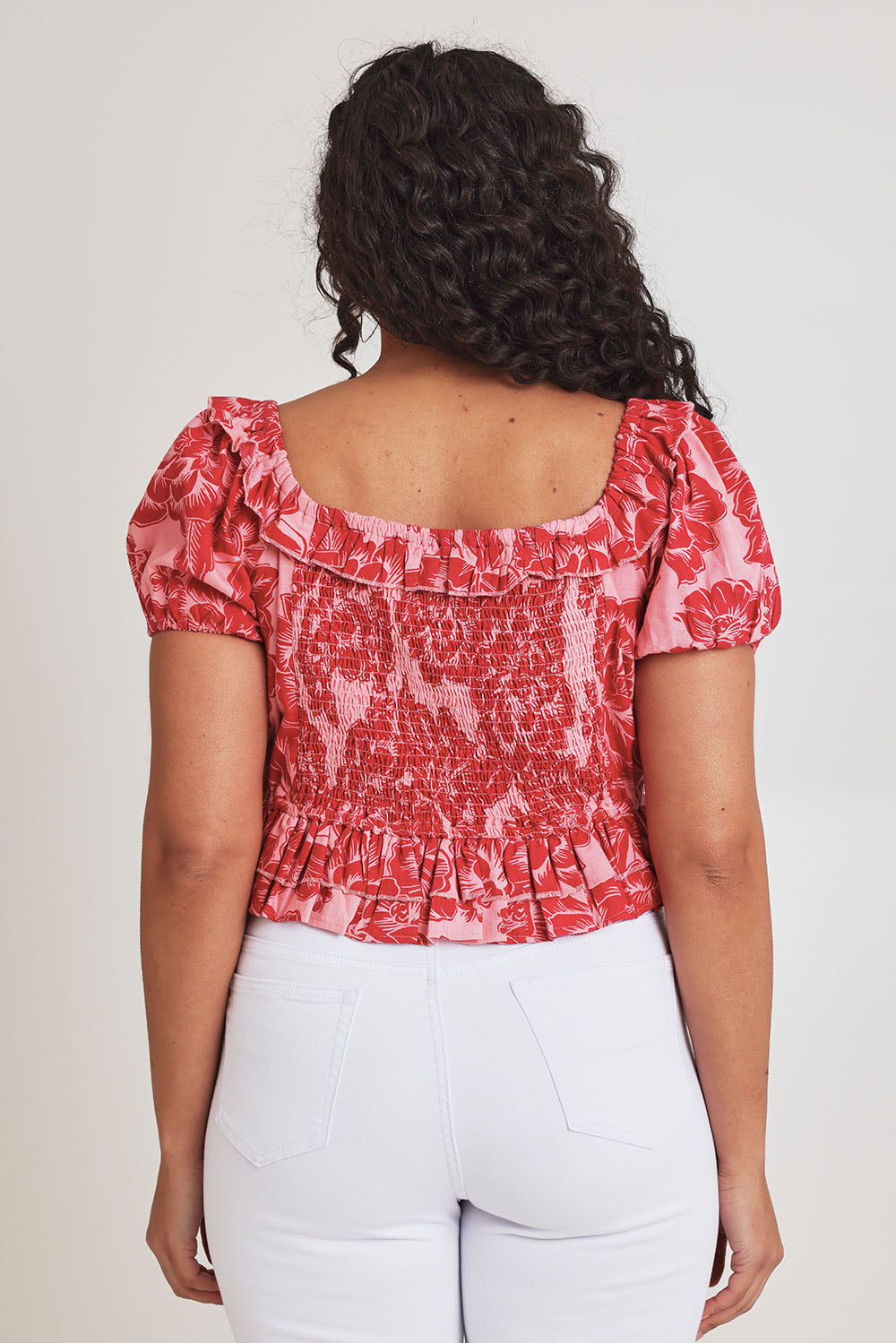 Model Terri-Leigh wearing size 14 of the Annie Cotton Frill Blouse in colour Blooming (Pink), from the back