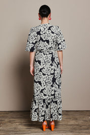 Model Katie wearing size 10 of the Anastasia Cotton Wrap Dress in colour Blooming (Black), from the back