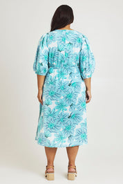 Model Ashleigh wearing size 16 of the Vivienne Cotton Dress in colour Rosettes (Blue), from the back