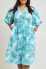 Model Ashleigh wearing size 16 of the Vivienne Cotton Dress in colour Rosettes (Blue), from the front, cropped image