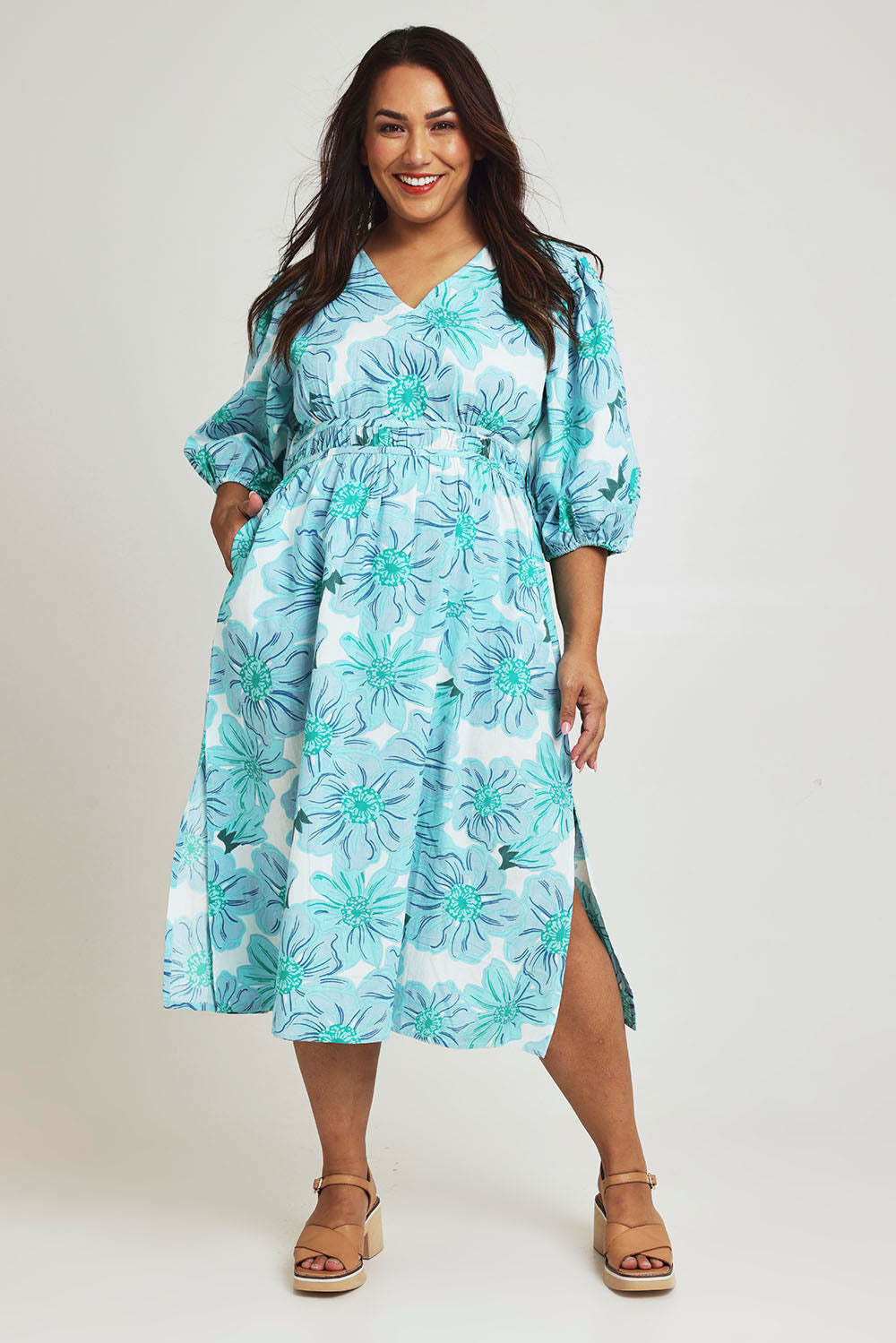 Model Ashleigh wearing size 16 of the Vivienne Cotton Dress in colour Rosettes (Blue), from the front, showing the whole outfit