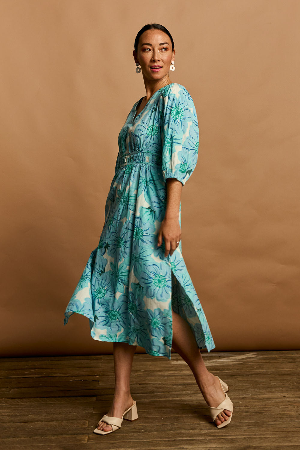 Model Katie wearing size 10 of the Vivienne Cotton Dress in colour Rosettes (Blue), from the front, showing the whole outfit