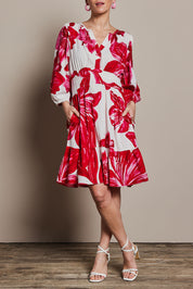 Model Katie wearing size 10 of the Gabrielle Dress in colour Lilly (Pink), from the front, cropped image