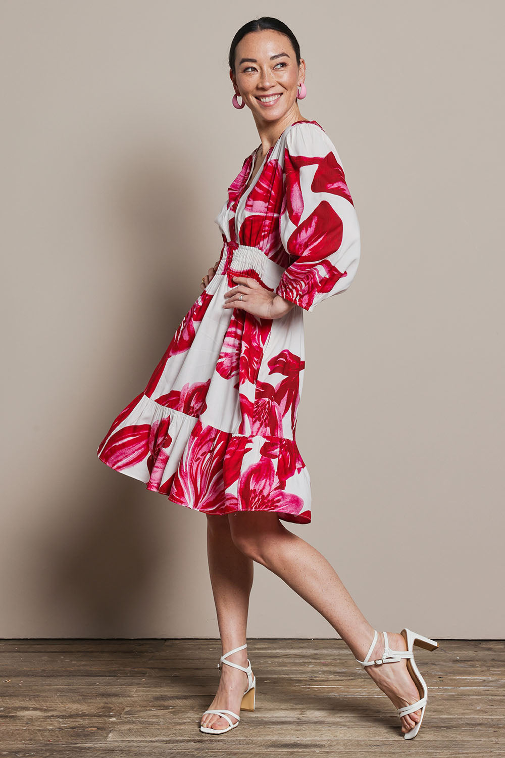 Model Katie wearing size 10 of the Gabrielle Dress in colour Lilly (Pink), from the front, showing the whole outfit