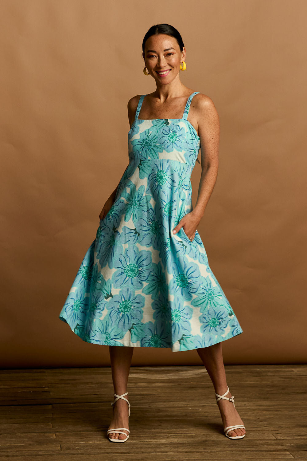 Model Katie wearing size 10 of the Shelby Cotton Dress in colour Rosettes (Blue), from the front, showing the whole outfit