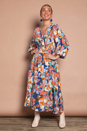 Model Katie wearing size 10 of the Gwyn Midi Dress in colour Botanical, from the front, showing the whole outfit