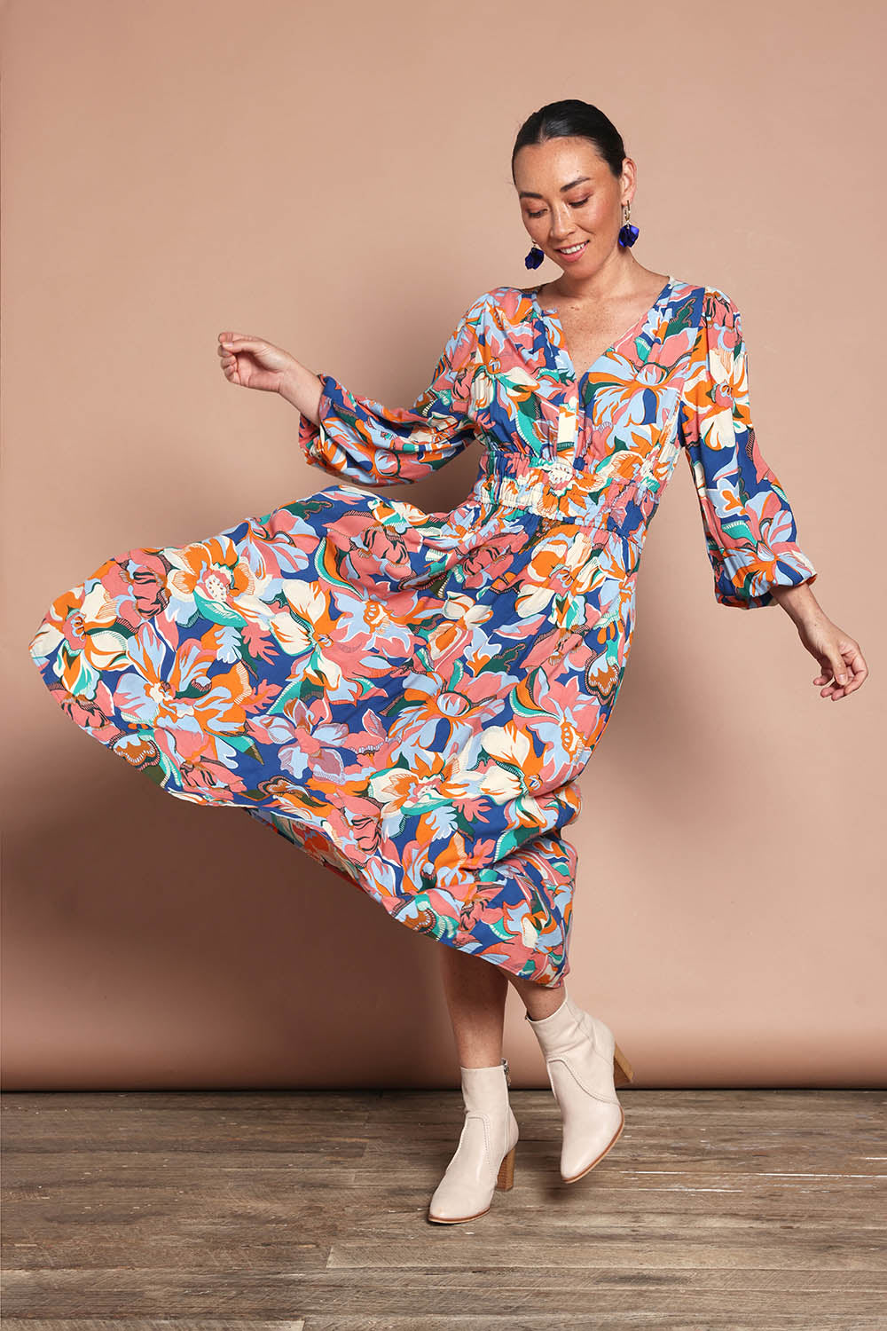 Model Katie wearing size 10 of the Gwyn Midi Dress in colour Botanical, from the front, showing the whole outfit