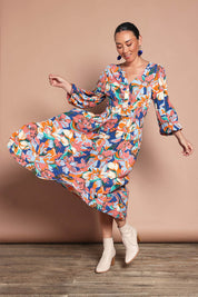 Model Katie wearing size 10 of the Gwyn Midi Dress in colour Botanical, from the front, showing the whole outfit