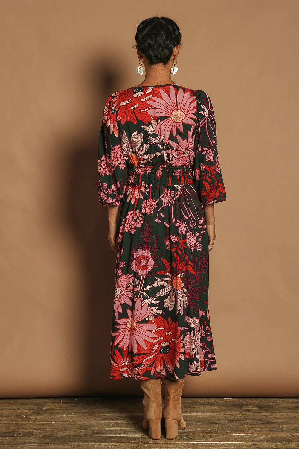 Model Katie wearing size 10 of the Gwyn Midi Dress in colour Greygarden (Pink), from the back