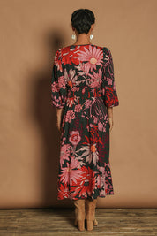 Model Katie wearing size 10 of the Gwyn Midi Dress in colour Greygarden (Pink), from the back