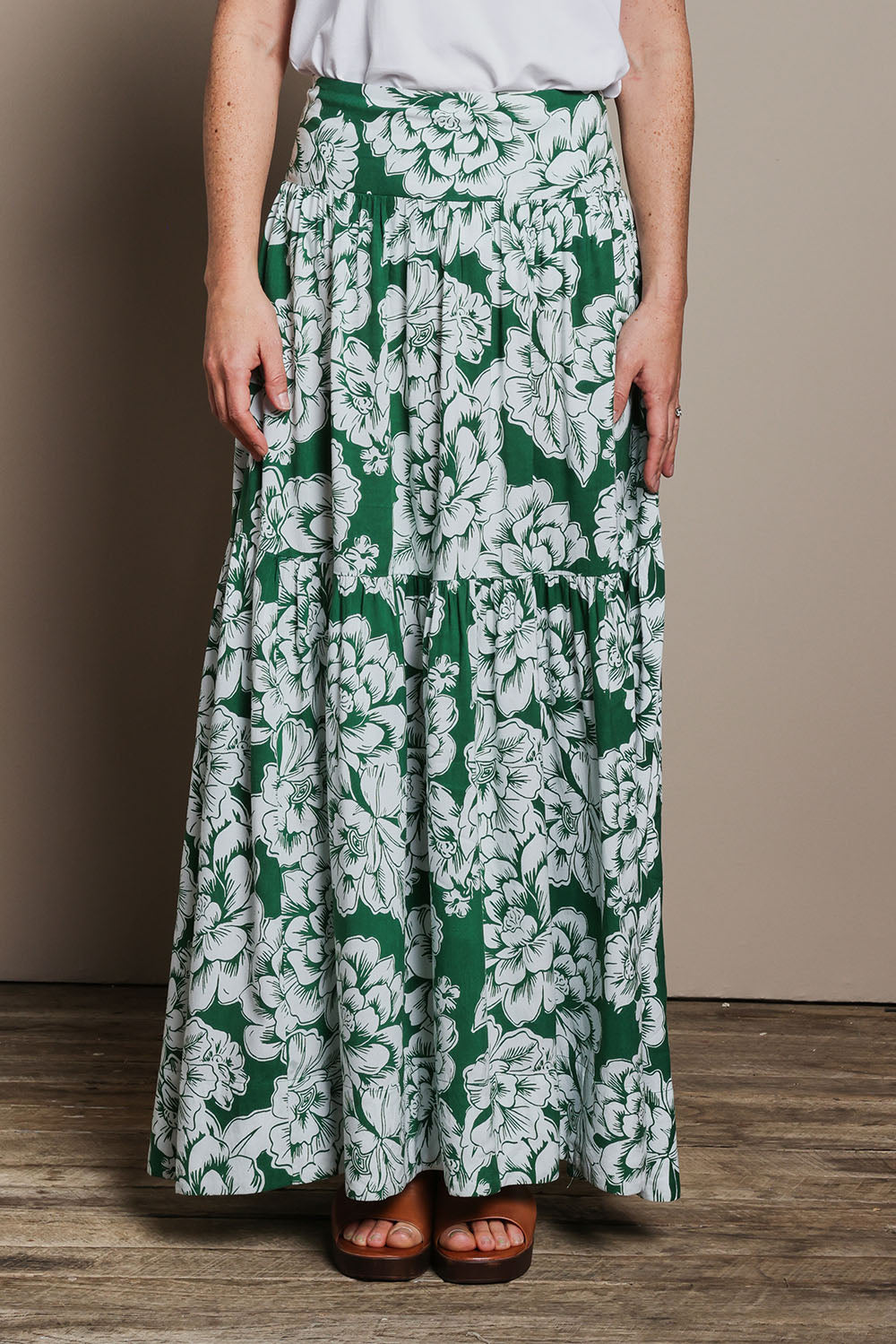 Model Katie wearing size 10 of the Ella Tiered Skirt in colour Blooming (Green), from the front, cropped image