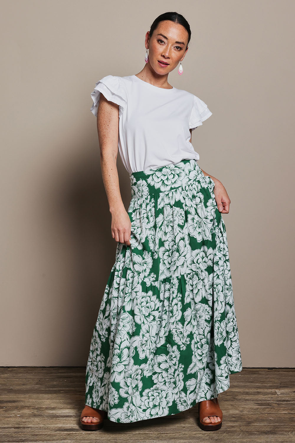 Model Katie wearing size 10 of the Ella Tiered Skirt in colour Blooming (Green), from the front, showing the whole outfit