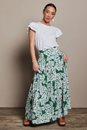 Model Katie wearing size 10 of the Ella Tiered Skirt in colour Blooming (Green), from the front, showing the whole outfit