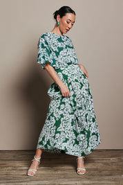 Model Katie wearing size 10 of the Ella Tiered Skirt in colour Blooming (Green), from the front, showing the whole outfit