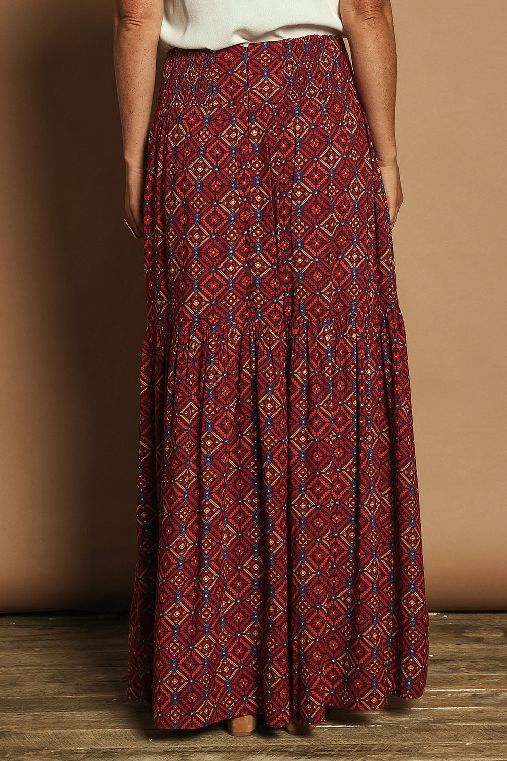 Model Katie wearing size 10 of the Ella Tiered Skirt in colour Geometric, from the back