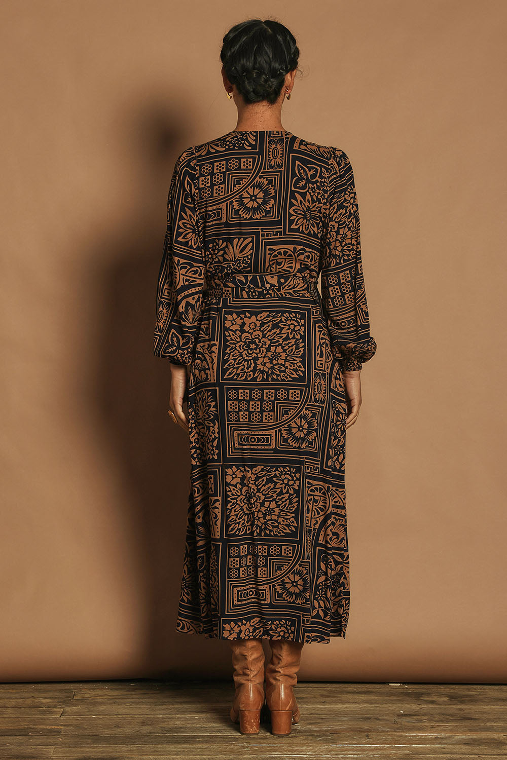 Model Katie wearing size 10 of the Derek Wrap Midi Dress in colour Labyrinth (Blue), from the back