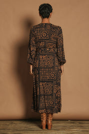 Model Katie wearing size 10 of the Derek Wrap Midi Dress in colour Labyrinth (Blue), from the back