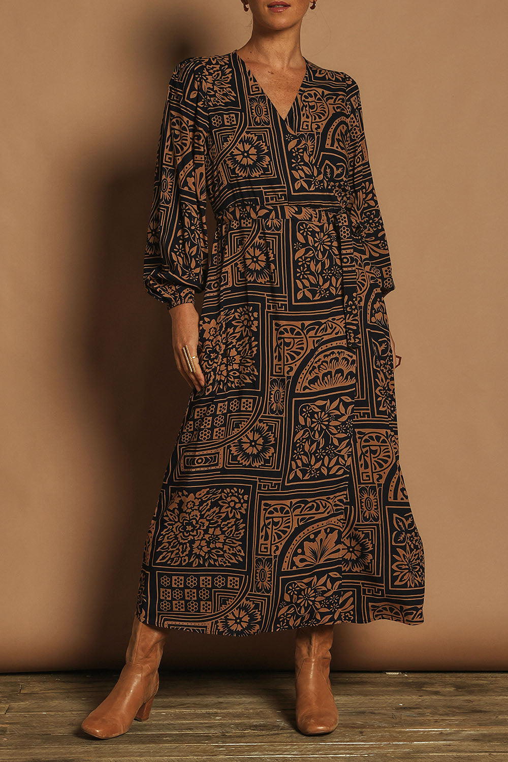 Model Katie wearing size 10 of the Derek Wrap Midi Dress in colour Labyrinth (Blue), from the front, cropped image