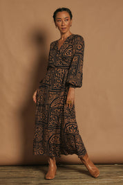 Model Katie wearing size 10 of the Derek Wrap Midi Dress in colour Labyrinth (Blue), from the front, showing the whole outfit