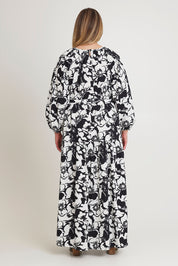 Model Chanel wearing size 16 of the Ruth Cotton Maxi Dress in colour Windfleur (Black), from the back