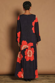 Model Katie wearing size 10 of the Ola Asymmetric Seam Dress in colour Boldflower (Blue), from the back