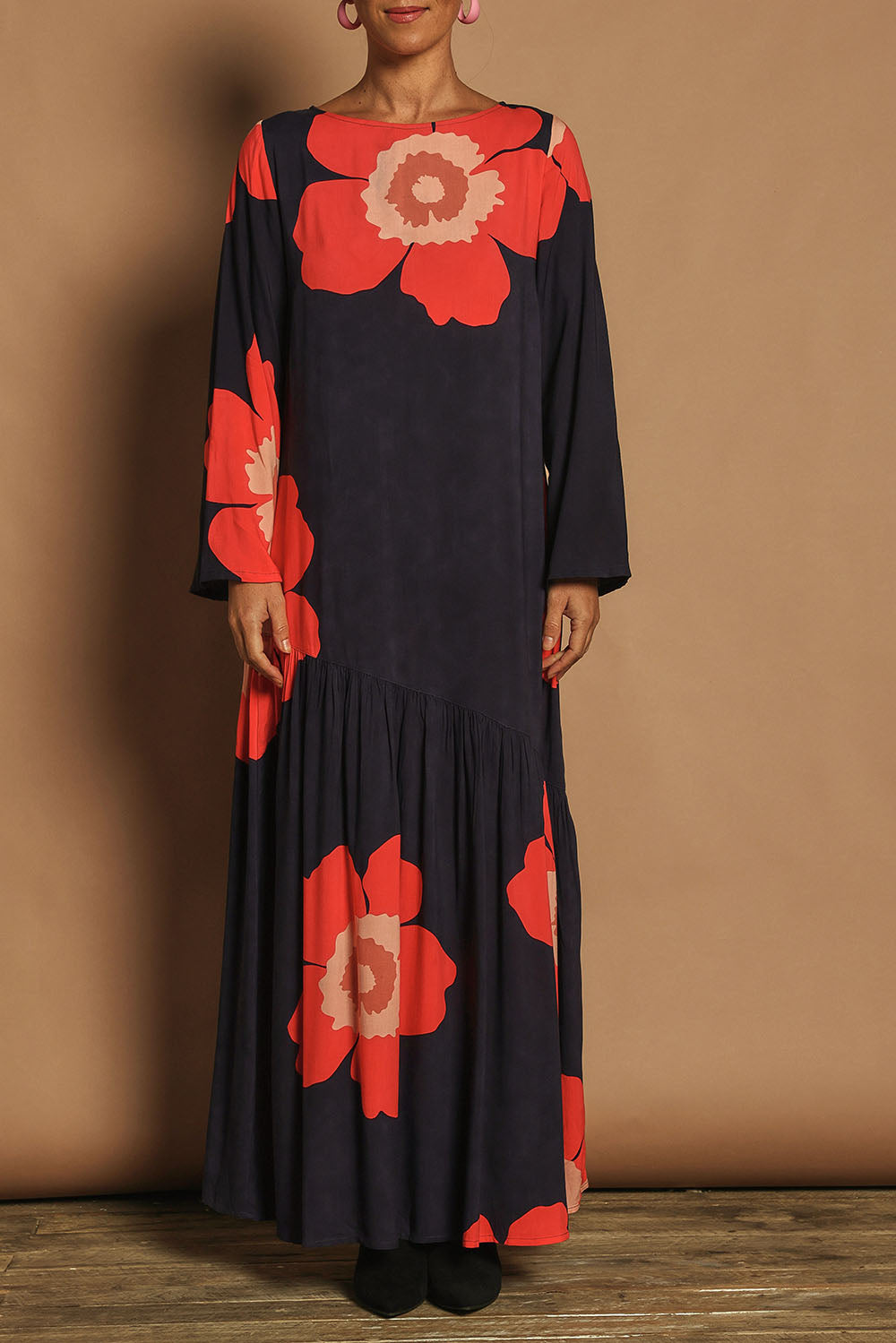 Model Katie wearing size 10 of the Ola Asymmetric Seam Dress in colour Boldflower (Blue), from the front, cropped image