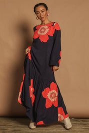Model Katie wearing size 10 of the Ola Asymmetric Seam Dress in colour Boldflower (Blue), from the front, showing the whole outfit